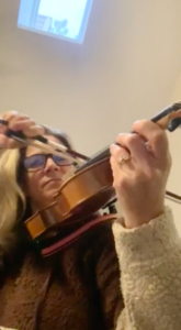 Jen trying to learn how to play the violin.